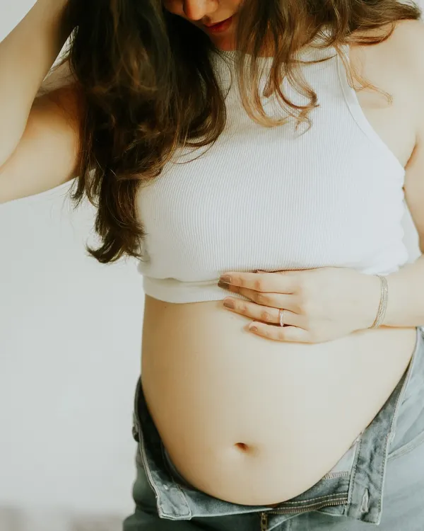 Sometimes, the bump deserves all the spotlight. This close-up shot in casual wear is perfect for camera-shy mamas who want to celebrate their pregnancy in a simple, beautiful way.