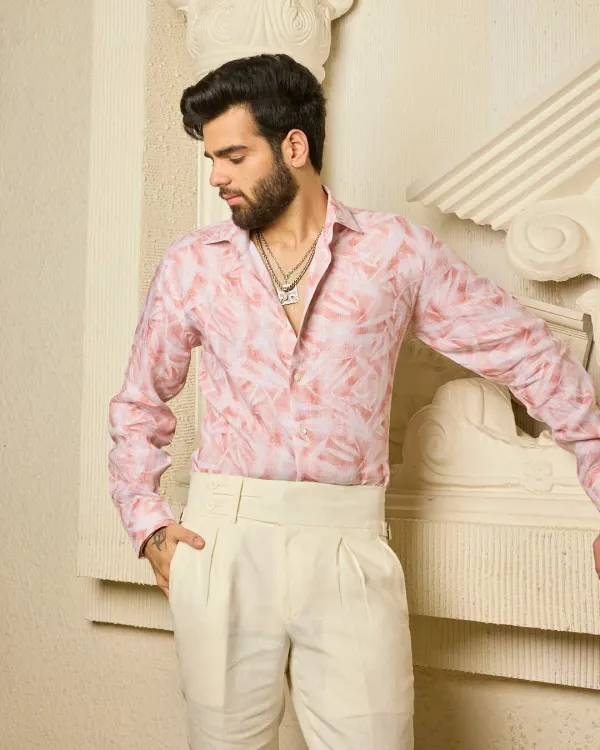 Breezy shades and timeless charm. This light pink linen shirt features a soft, abstract leaf-like pattern and is paired with cream pleated trousers for an effortlessly elegant summer look.
