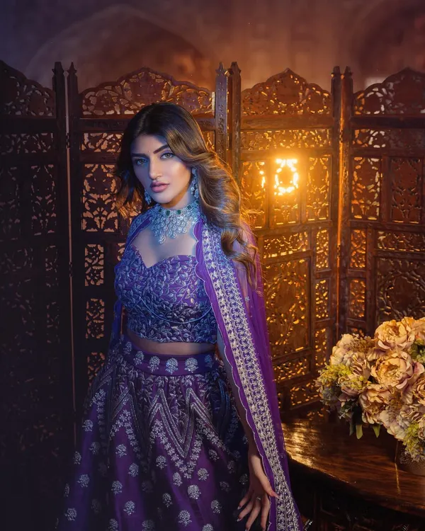 A regal purple lehenga for actress Sreeleela. The intricate silver embroidery and diamond jewelry were chosen to create a look of pure elegance for this studio photoshoot.