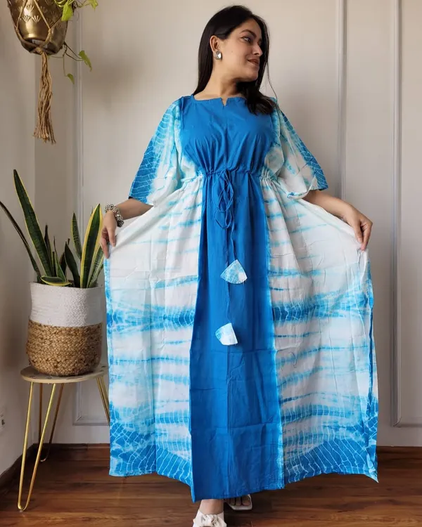 A beautiful tie-dye cotton kaftan in shades of blue and white. This piece features a central panel design and an adjustable drawstring waist for a comfortable, flattering fit.