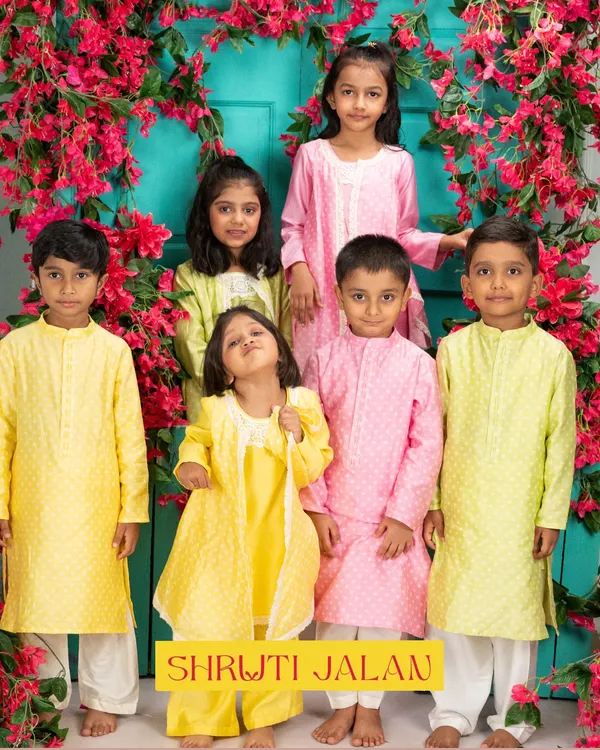 I design clothes that are as bright and happy as the little ones wearing them. This moment, with a group of friends dressed in my pastel collection, captures the pure joy of celebration I aim for in every stitch.