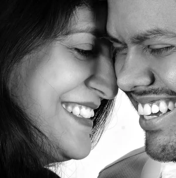 A candid, close-up couple portrait in black and white. I love capturing these genuine moments of laughter and connection, which make for timeless and emotional photographs.