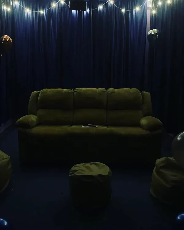 A clear view of our comfortable seating options. We have a plush three-seater recliner sofa and extra bean bags so everyone has a cozy spot to relax.