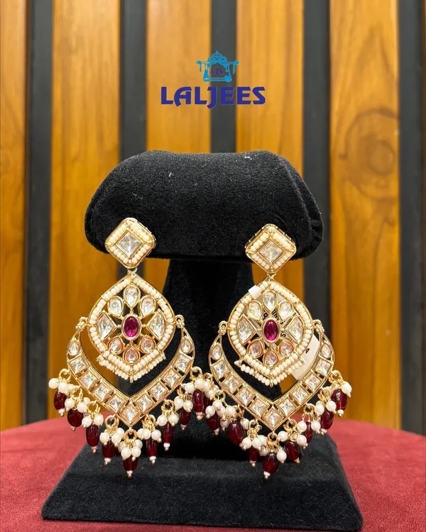 A beautiful pair of kundan and ruby chandbali earrings, perfect for adding a touch of tradition to any outfit.