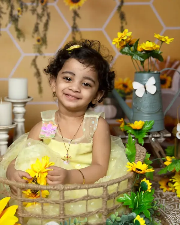 A heartwarming smile surrounded by sunflowers. This close-up from a sunflower-themed session is full of joy and brightness.