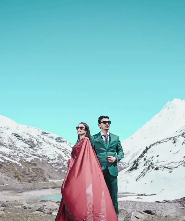 A dramatic pre-wedding portrait session against the stunning backdrop of snow-covered peaks in Manali. I love using bold colors and epic landscapes to create unforgettable images that tell your unique love story.