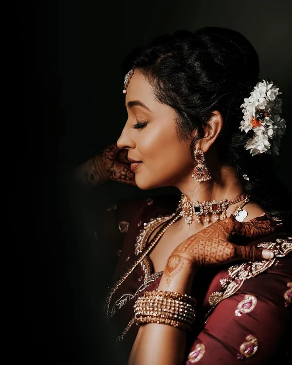 A beautiful client photo from her engagement, where you can see a glimpse of the intricate mehendi on her hands, complementing her traditional attire.