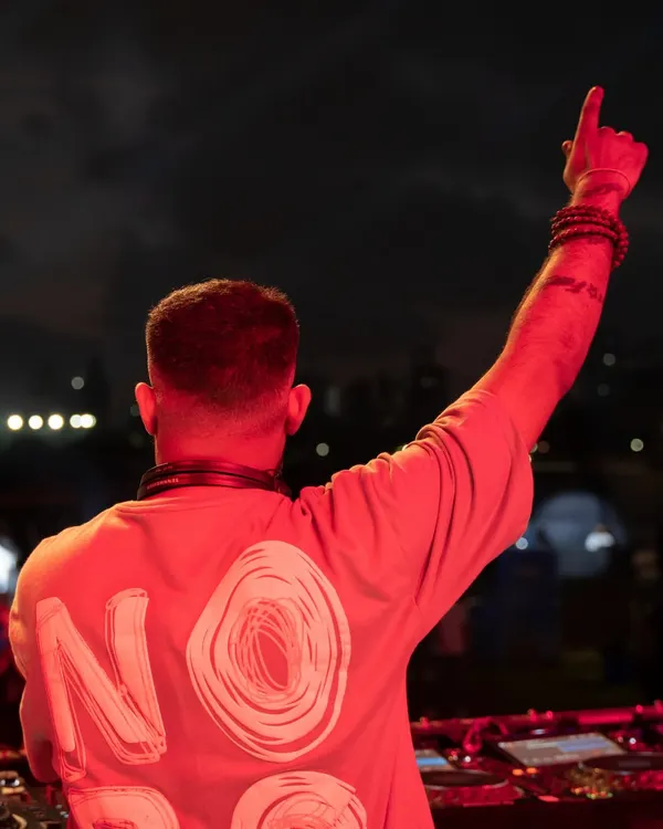 A shot from behind, showing my "NOBO" shirt while pointing to the sky. It's all about representing the brands and communities that support the music.