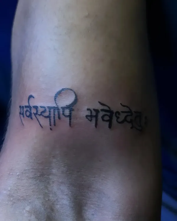 A close-up of a Sanskrit script tattoo reading "Sarvasyapi Bhavatu." I take great care to ensure every character is accurately and beautifully rendered, respecting the importance of the text.