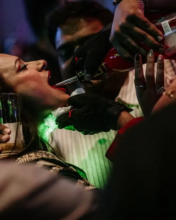 This is what I call keeping the party alive. We don't just stay behind the bar; we get into the crowd and make sure everyone, like this happy guest, gets their favorite drink poured right on the dance floor.