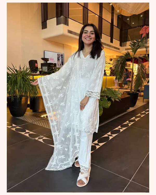 A classic white kurta set is a wardrobe essential. This piece features delicate embroidery and lace details, making it a timeless and elegant choice for any day.