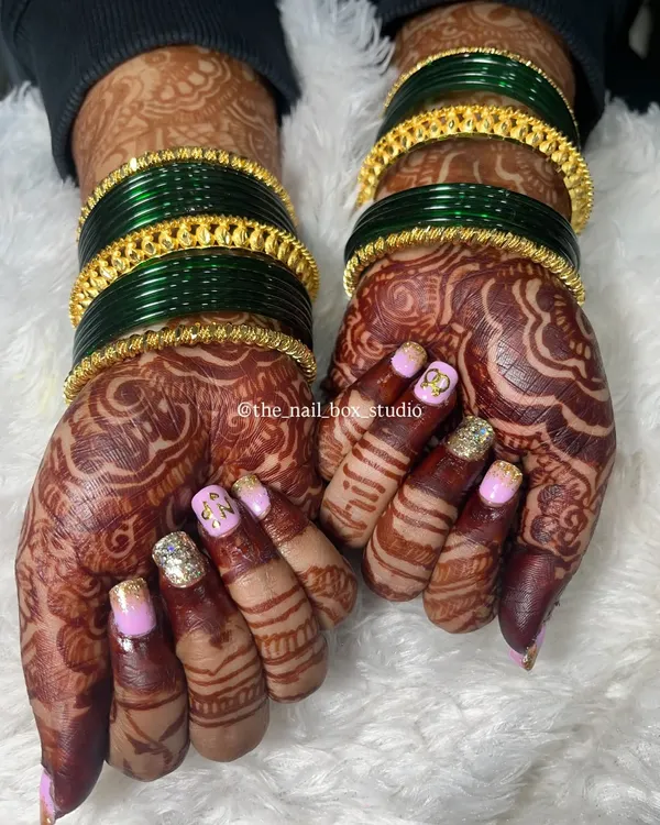 This is one of my favorite engagement sets. I created custom initial nail art with 'N' and 'P' for the couple, combined with a beautiful pink and gold glitter ombré. This design works perfectly with the intricate mehndi and traditional green and gold bangles.