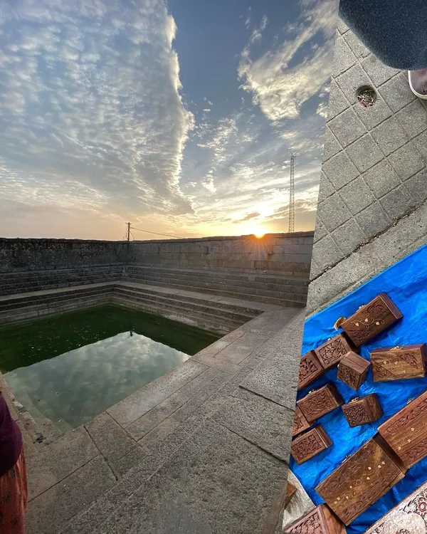 Recent atmospheres, past and present. A collage pairing the ancient stone of a stepwell at sunset with modern, handcrafted wooden boxes from a street market.