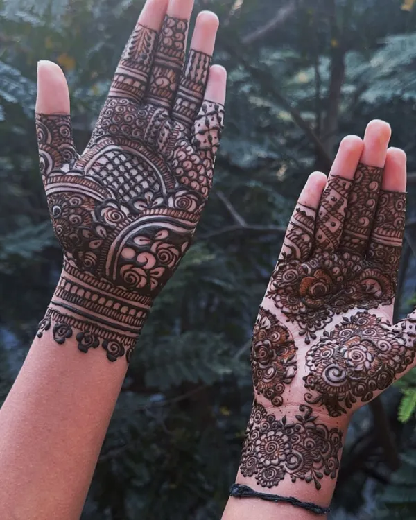 This design perfectly captures the Indo-Arabic style, with a bold, cuff-like pattern on one hand and a more delicate, floral mandala on the other. It's a unique and contemporary choice.
