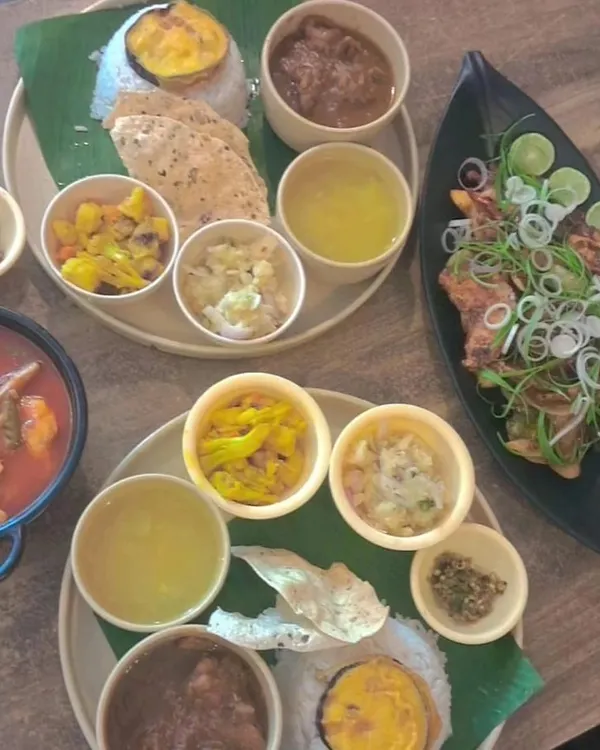 A beautiful spread of our different thalis and side dishes. Each thali is a balanced meal, offering a variety of tastes and textures, from spicy curries to simple boiled vegetables and tangy chutneys.