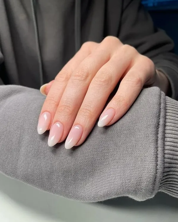 A perfect example of a classic "baby boomer" ombré manicure. The seamless blend from a soft pink base to a white tip gives a timeless and clean look.