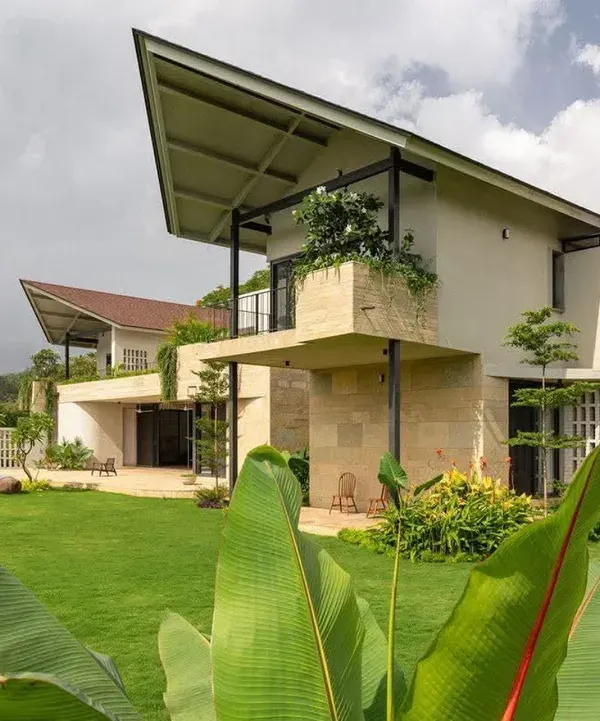 A modern architectural villa complemented by a lush, manicured lawn and strategically placed greenery. This project showcases the seamless integration of landscape design with high-end residential properties, including poolside planting.