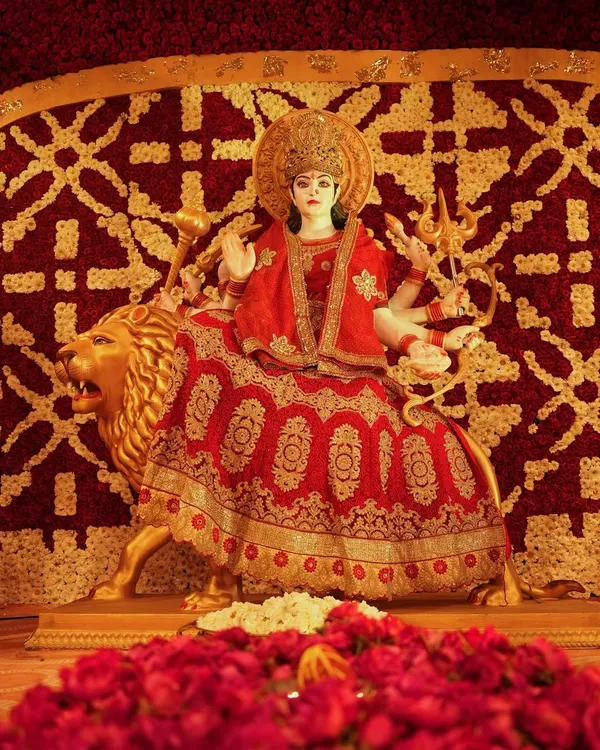 For this Durga Puja, the deity was framed by an intricate backdrop made entirely of red and gold flowers. We used thousands of blooms to create a traditional pattern, providing a rich and reverent setting for the goddess.