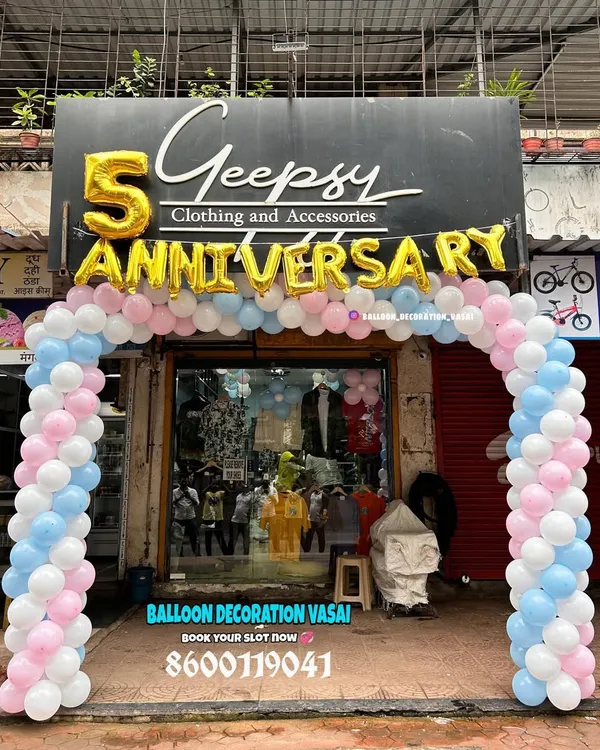 For the 5th anniversary of a clothing store, I set up this welcoming balloon arch right at the entrance. The design uses soft pink, blue, and white balloons with large gold foil letters to attract customers and celebrate the occasion.
