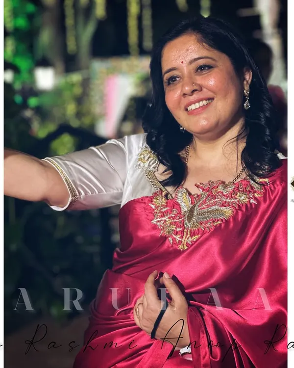 Every saree has a story. I'm wearing a new-age satin saree with a custom-designed white blouse featuring a beautiful bird motif embroidered on the neckline.