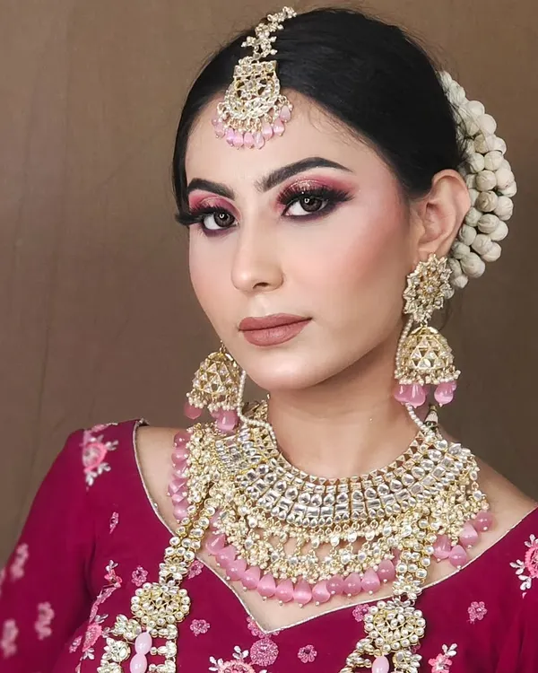 This look features a beautiful pink lehenga paired with a matching pink-beaded Kundan jewellery set, perfect for a soft and romantic bridal shoot.