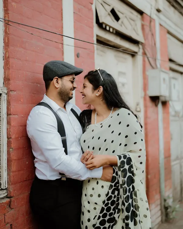 A sweet moment from a retro-themed shoot in the old lanes of Pune. The vintage-style clothing and the classic architecture create a timeless feel.