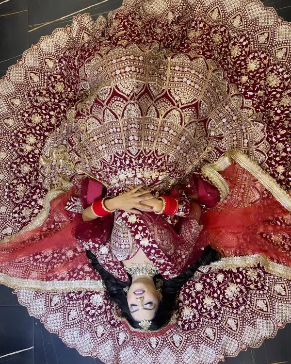 This is the kind of bridal magic I love to create. This shot captures the grandeur of a traditional wedding look, focusing on a flawless base, dramatic eyes, and a pose that makes the bride the absolute star of her day.