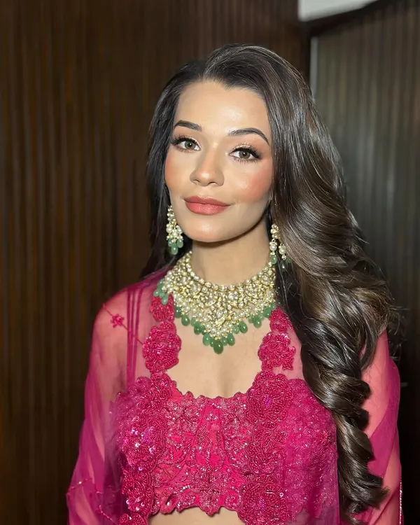 Drenched in red, glowing in glam. This look for Tanisha features a warm smokey eye and luminous skin, perfect for an evening celebration.
