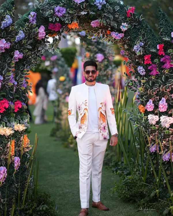 A full view of my hand-painted bandhgala zipper jacket, perfect for a daytime wedding ceremony. The custom artwork with birds and florals adds a unique, personal touch to the groom's ensemble, setting him apart with sophisticated style.