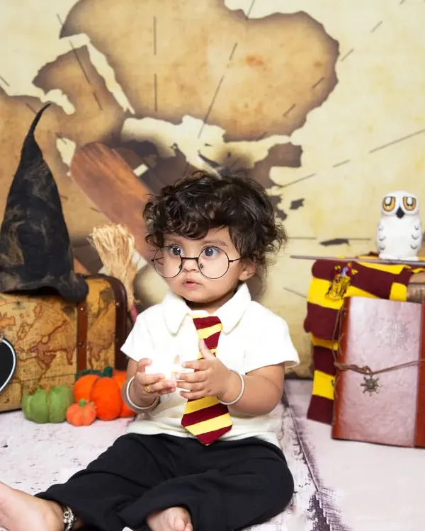 Ready for Hogwarts! This little wizard, complete with glasses and a tie, is all set for his Harry Potter themed sitter session.