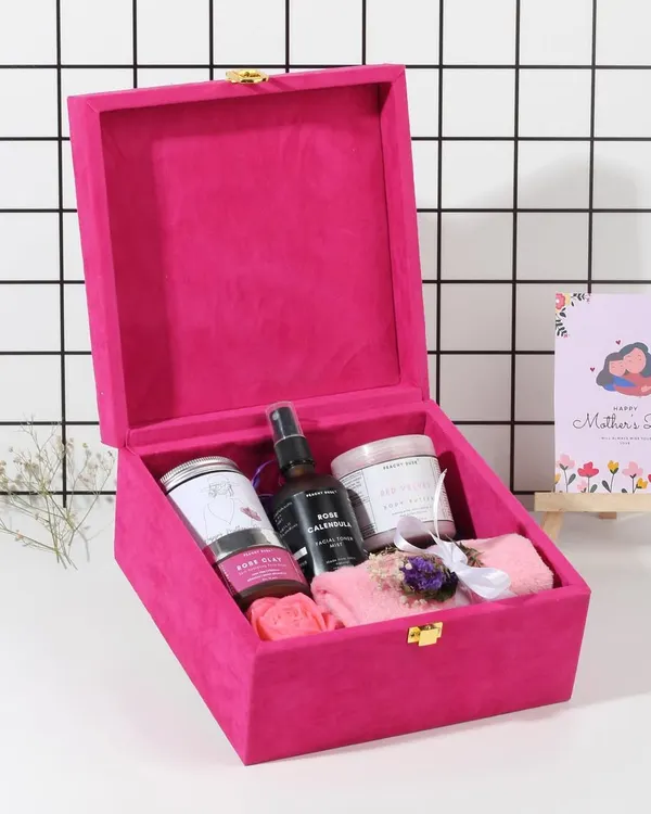 My Mother's Day hamper presented in a luxurious pink velvet box. It's filled with everything she needs for a spa day at home, including body butter, a facial mask, and a rose calendula mist.