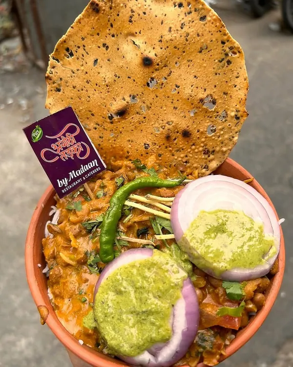 Our Rajma Chawal served in a traditional kulhad, topped with fresh onions, green chutney, and a crispy papad. This is the ultimate comfort food, full of authentic Punjabi flavor.