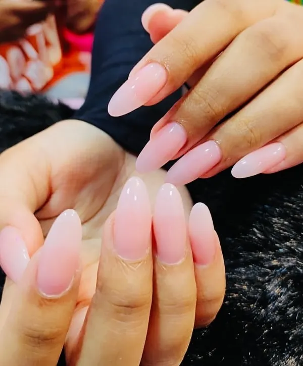 The definition of simple elegance. This is a beautiful set of long, almond-shaped nails with a semi-sheer pink gel overlay. It enhances the natural nail while providing strength and a flawless, glossy finish.