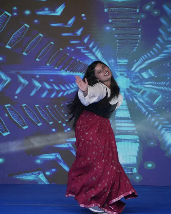 A student captivates the audience with an energetic dance performance during a YMCA event. We encourage all our students to participate and express their creativity.