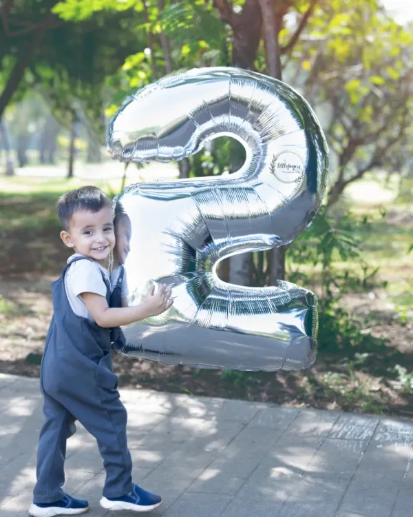 That happy smile says he is two. Using large number balloons is a fun and classic way to mark a birthday milestone during our outdoor photoshoots.