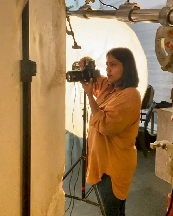 Here I am, in my element. This is a candid shot of me during a studio session, completely focused on finding the right angle and capturing the perfect moment.
