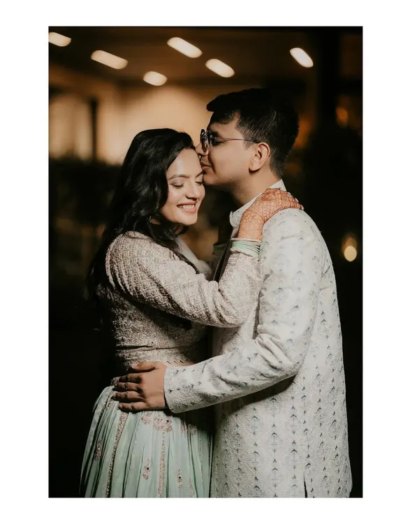 A sweet and intimate moment from a roka ceremony. The groom's gentle kiss on his fiancée's forehead perfectly captures the love and excitement of this special day.
