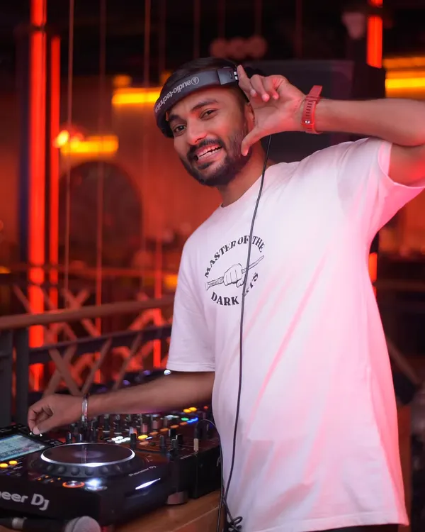 In my element, headphones on, hand on the deck. This is my office. I'm focused on the mix, ensuring every transition is smooth and the energy keeps building.