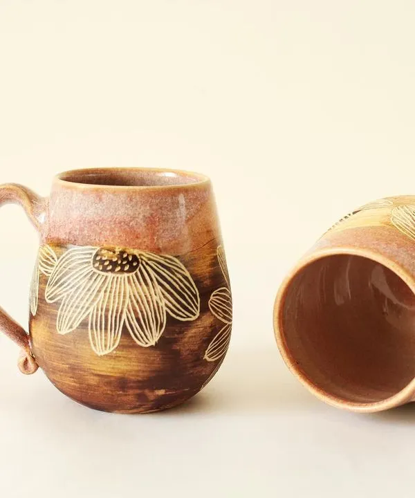 A pair of my Pink Sienna mugs, each showing a unique blend of glossy glaze and raw, carved texture. They are perfect for sharing a morning coffee with someone special.