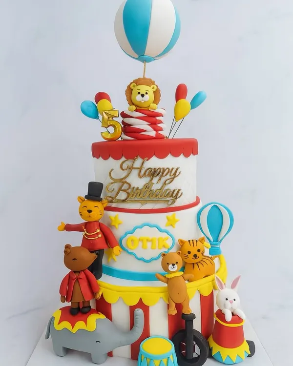 This multi-tiered circus-themed cake is a testament to our love for detailed, imaginative designs. We handcraft each character, from the balancing bear to the lion, with fondant to bring your party's theme to life in the most delicious way.