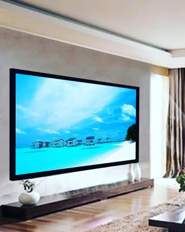 A fixed-frame projector screen installed in a contemporary living room. This setup provides a dedicated, perfectly flat surface for the best possible image quality, turning your main living space into a dual-purpose media room.