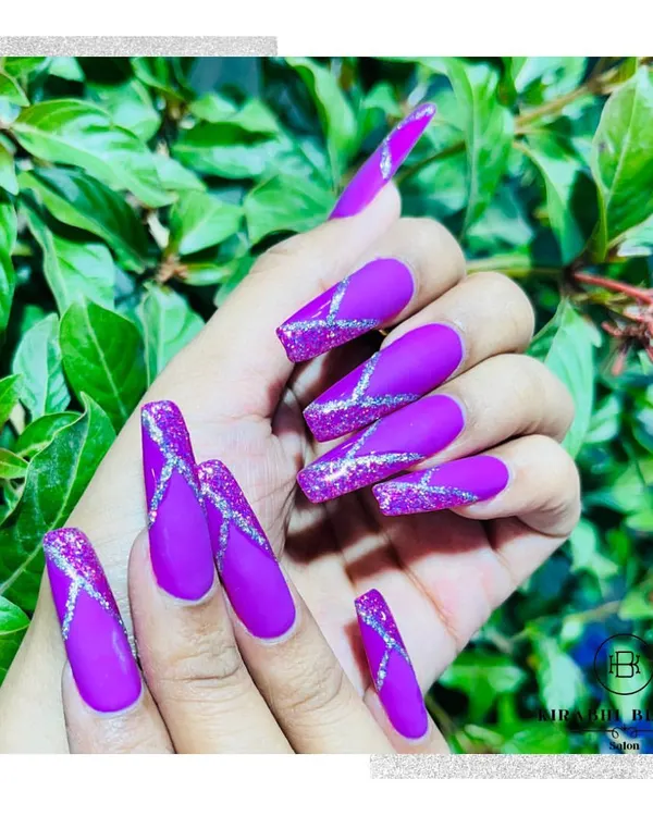 This look is all about drama. I used a rich, matte purple gel polish as the base and added intersecting lines of silver glitter for a striking contrast and texture.