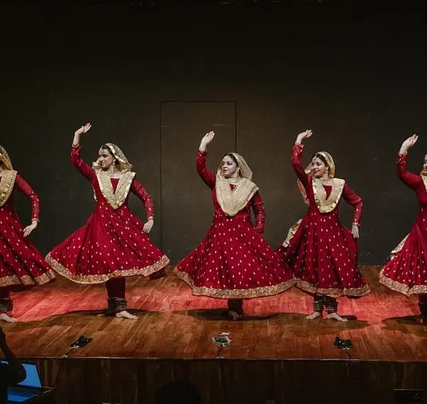 My dancers in a classic Kathak pose during a performance. The traditional costume, with its wide flare, is designed to accentuate the beauty of the spins and movements.