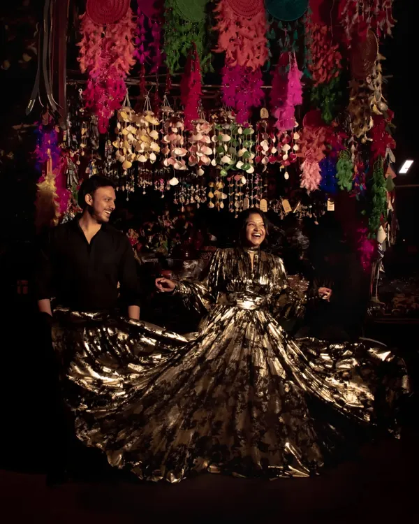 This is my custom-designed Black Bloom split-ruffled dress, created for a client's special celebration. The flowing, metallic fabric creates incredible movement and drama, making it a perfect statement piece for any festive occasion.