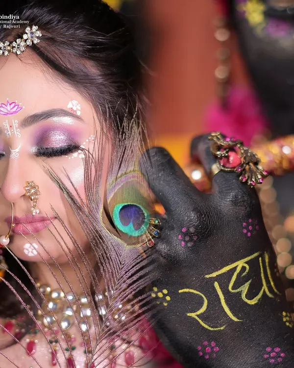 A truly artistic creation where makeup tells a divine story. This look involves intricate details, body painting, and thematic styling to represent Radha and Krishna.