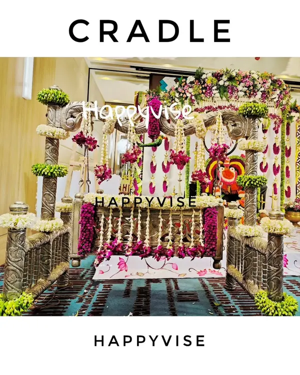 The cradle is the star of the naming ceremony. Here, an ornate silver cradle is beautifully decorated with garlands of fresh jasmine and purple flowers for a traditional 'thottilu shastra'.