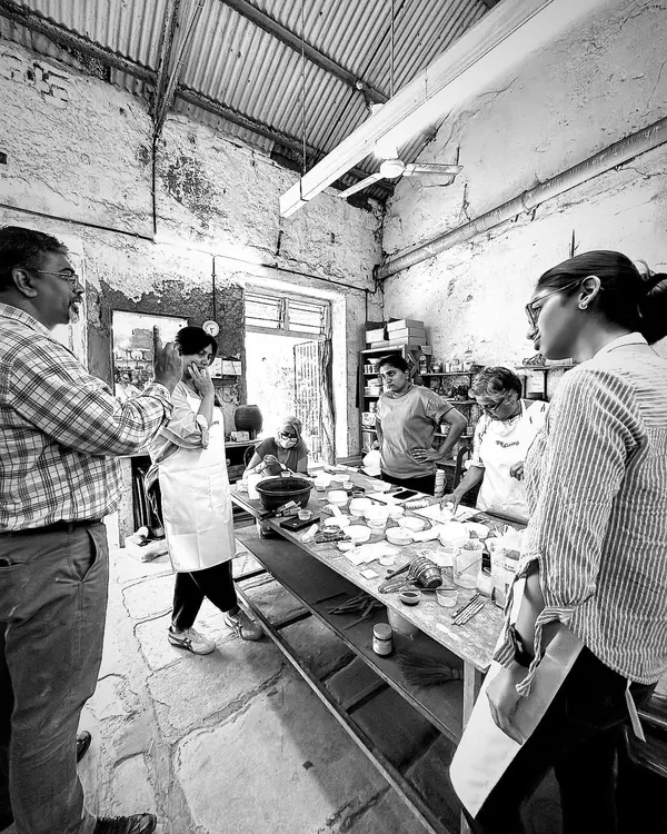 A moment from our masterclass on clay bodies and glazes. Here, I am discussing techniques with participants in the middle of our working studio, surrounded by the tools and materials of the craft.