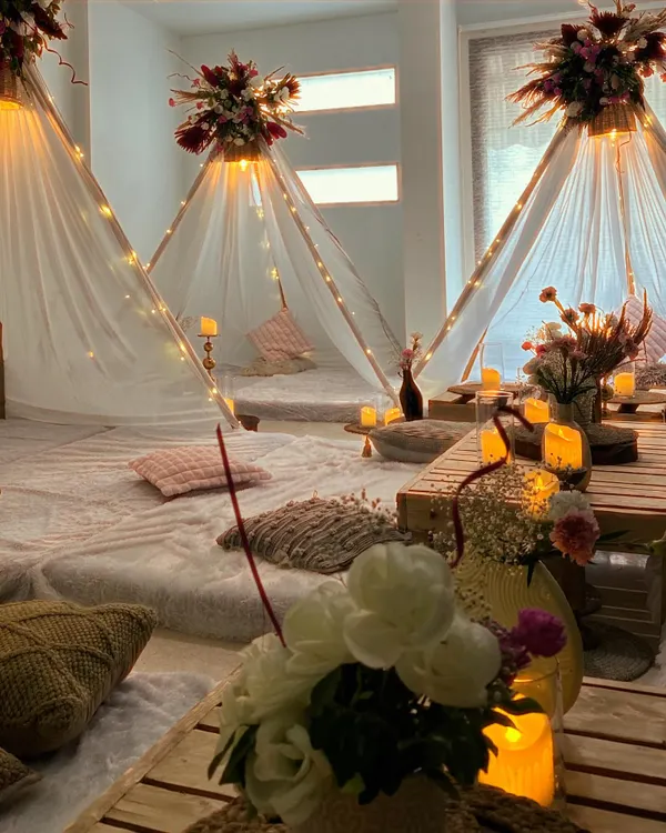 This is what we mean by upgrading your home celebrations. We transformed a living room into this dreamy, cozy wonderland for a slumber party, complete with individual teepees, soft lighting, and lush floral toppers. It’s all about creating a magical escape, right where you are.
