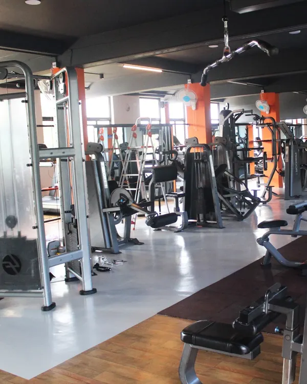 A wide view of our strength training floor, packed with a variety of branded machines. We have everything you need to target every muscle group for a comprehensive workout.