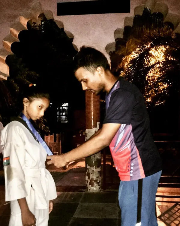 A proud moment as I award a medal to a student after the North Districts Taekwondo Championship. Recognizing their hard work is an important part of their journey.